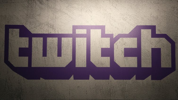 The purple logo of Twitch on a wall.