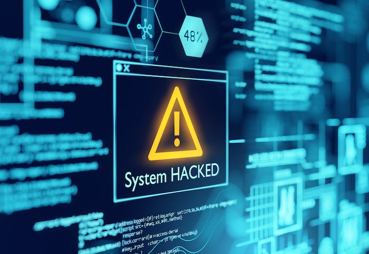 computer screen with the words SYSTEM HACKED displayed
