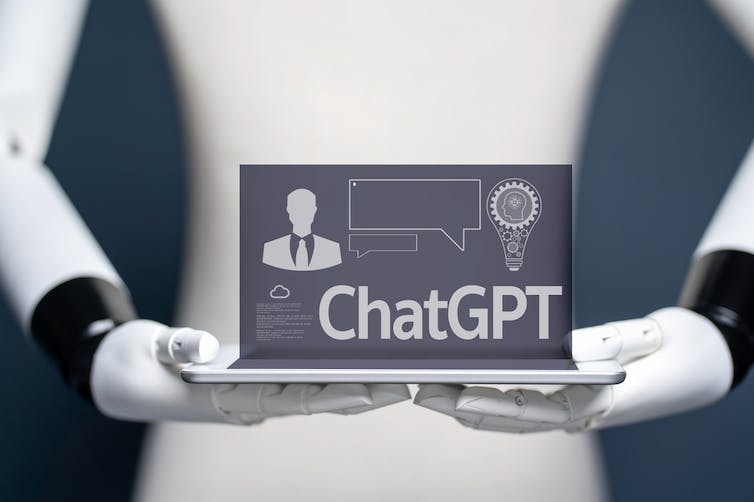 Robot holding a laptop with chatGPT on it.