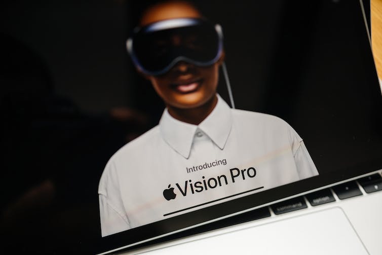 webpage of Apple on iPad Pro XR showcasing with tilt-shift lens the word Apple Vision Pro mixed reality XR headset.