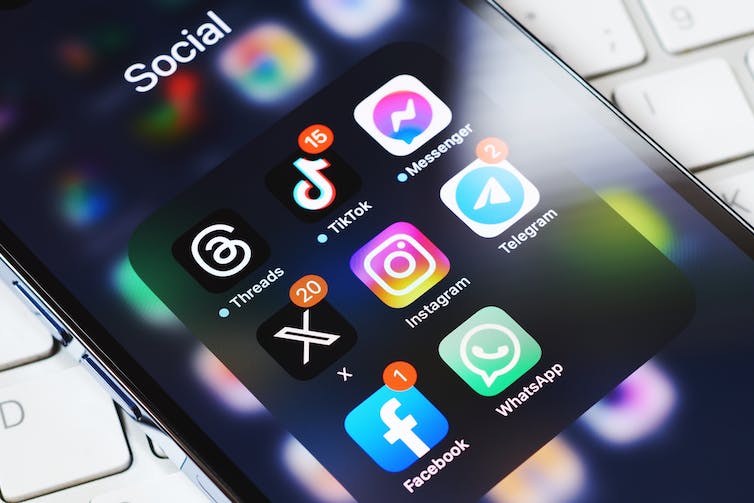A close up of a mobile phone screen displaying several social media apps.