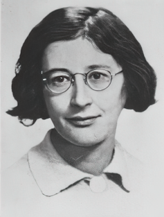 A headshot of Simone Weil, around age 16. She has short hair and glasses.