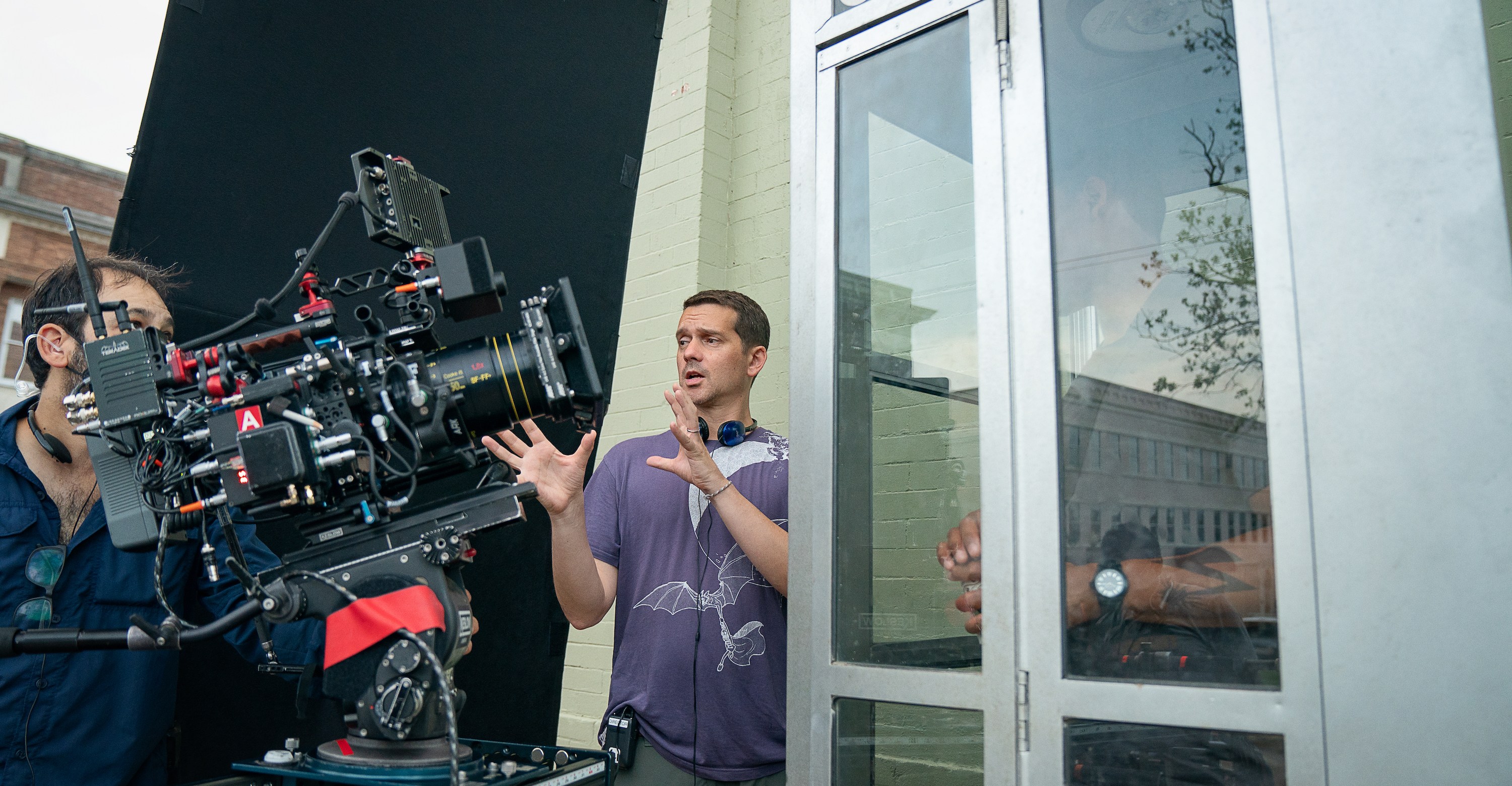 Director Jeremy Saulnier speaks to a camera operator on the set of Rebel Ridge as star Aaron Pierre stands in a phone booth
